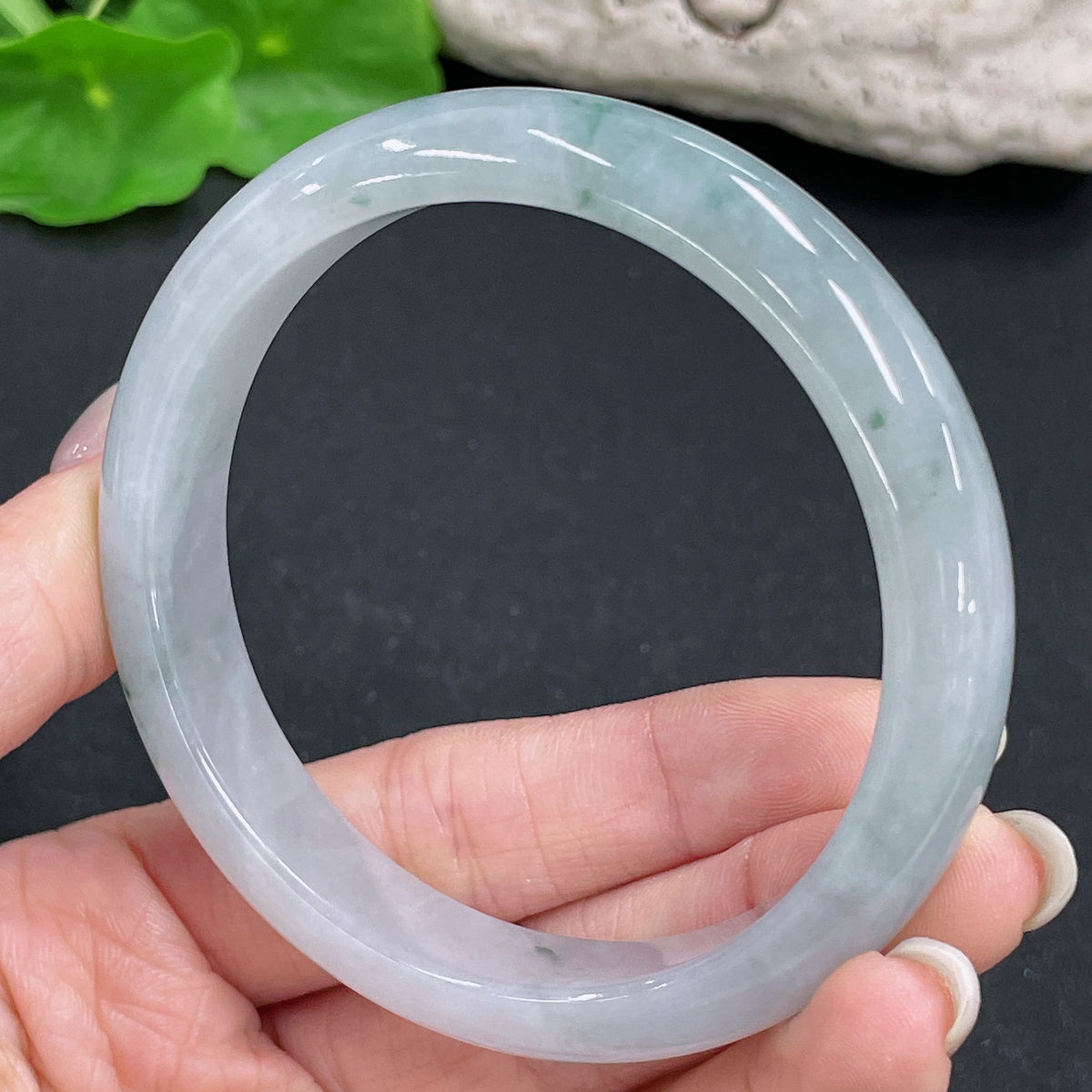 Jadeite round bangle in size 59.3, weighing approximately 51.46g, crafted from green jadeite with smooth polished surface.