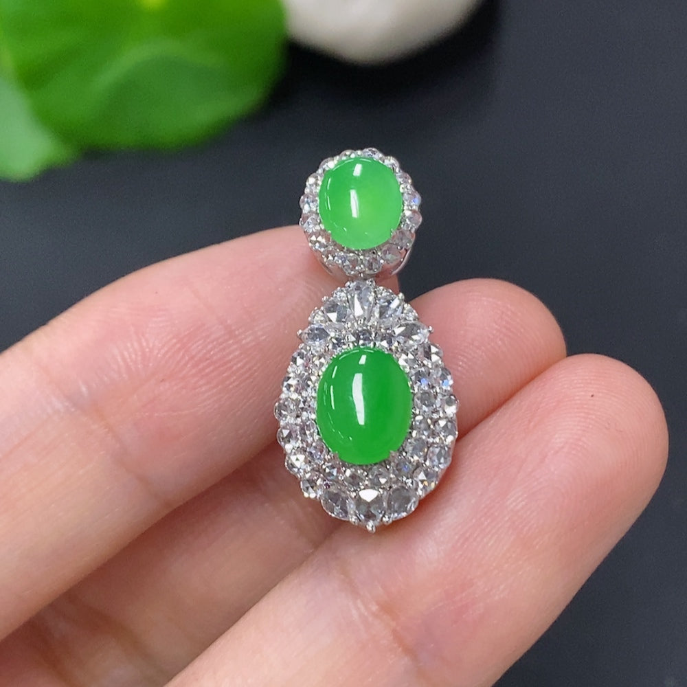 Jadeite cabochon pendant with diamond accents in 18K gold, featuring a polished jade gemstone with intricate gold detailing.