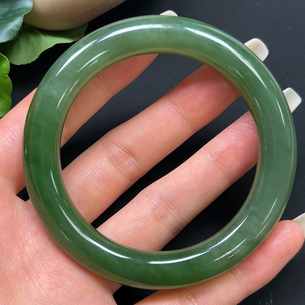 Round Hetian Jade bangle bracelet by HKHQ, size 55.4, weighing 56.99g, featuring smooth polished green jade surface.