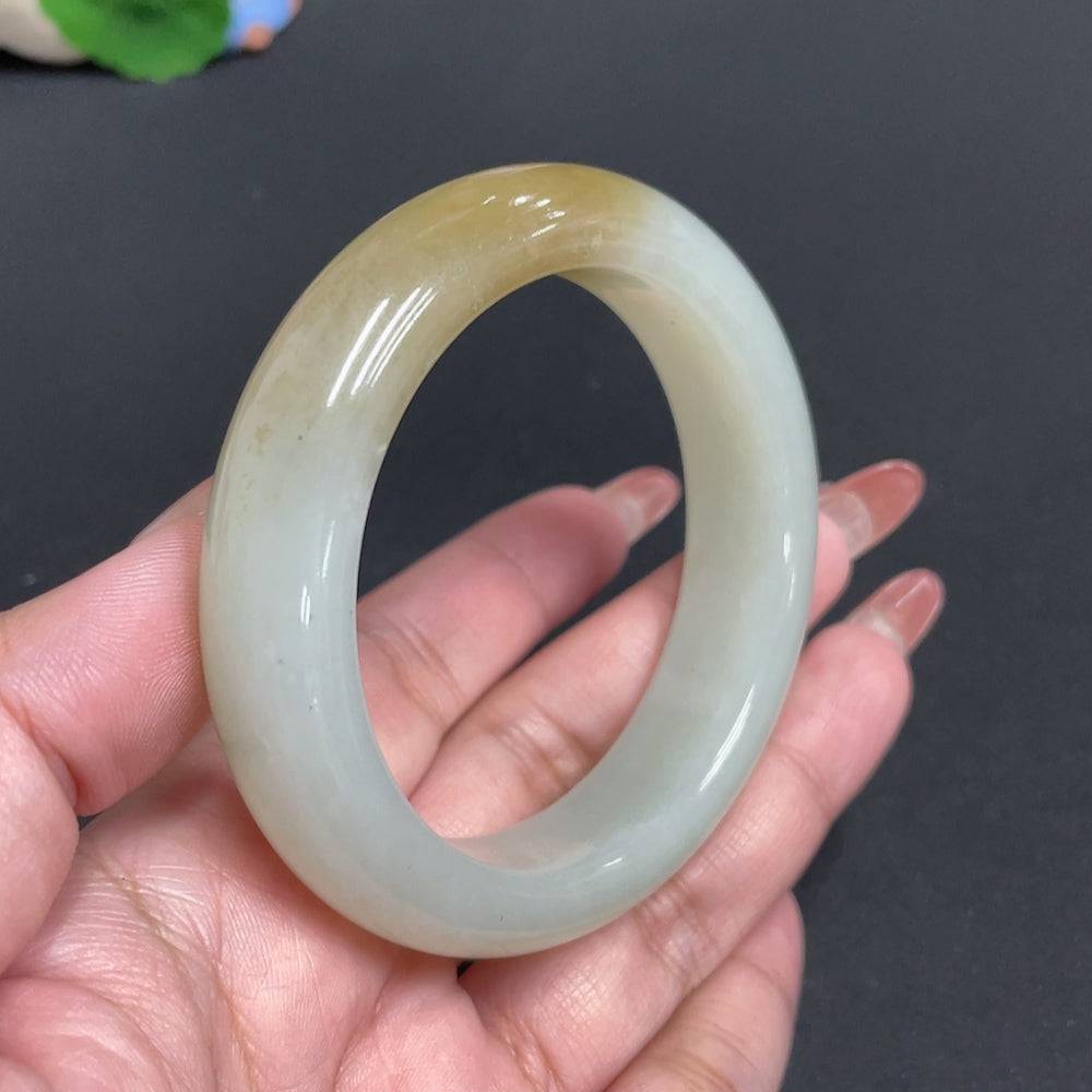 Round Hetian jade bracelet by HUILIU HQ, size 57.6, with polished smooth finish and natural green color, weighing approx. 75.2g.