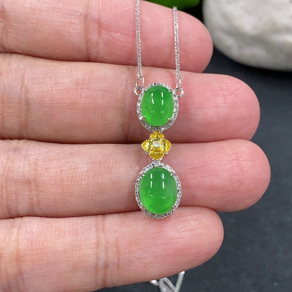Jadeite cabochon pendant necklace with 18K gold and diamond accents, featuring a polished green jade stone on a gold chain.