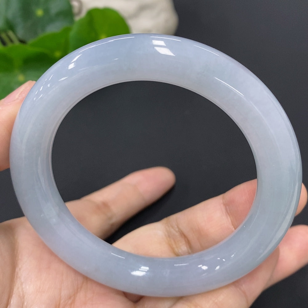 Huiliu Certified Jadeite round bangle showcasing smooth, polished green jade with a glossy finish and traditional circular shape.