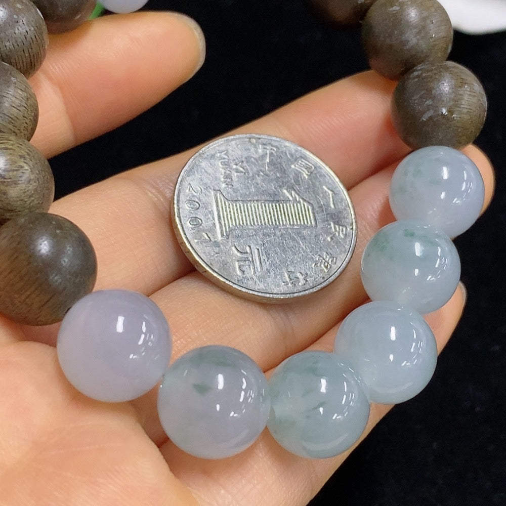Three 12.5mm Huiliu certified jadeite beads by HKHQ, showcasing smooth, polished green jade with natural variations.