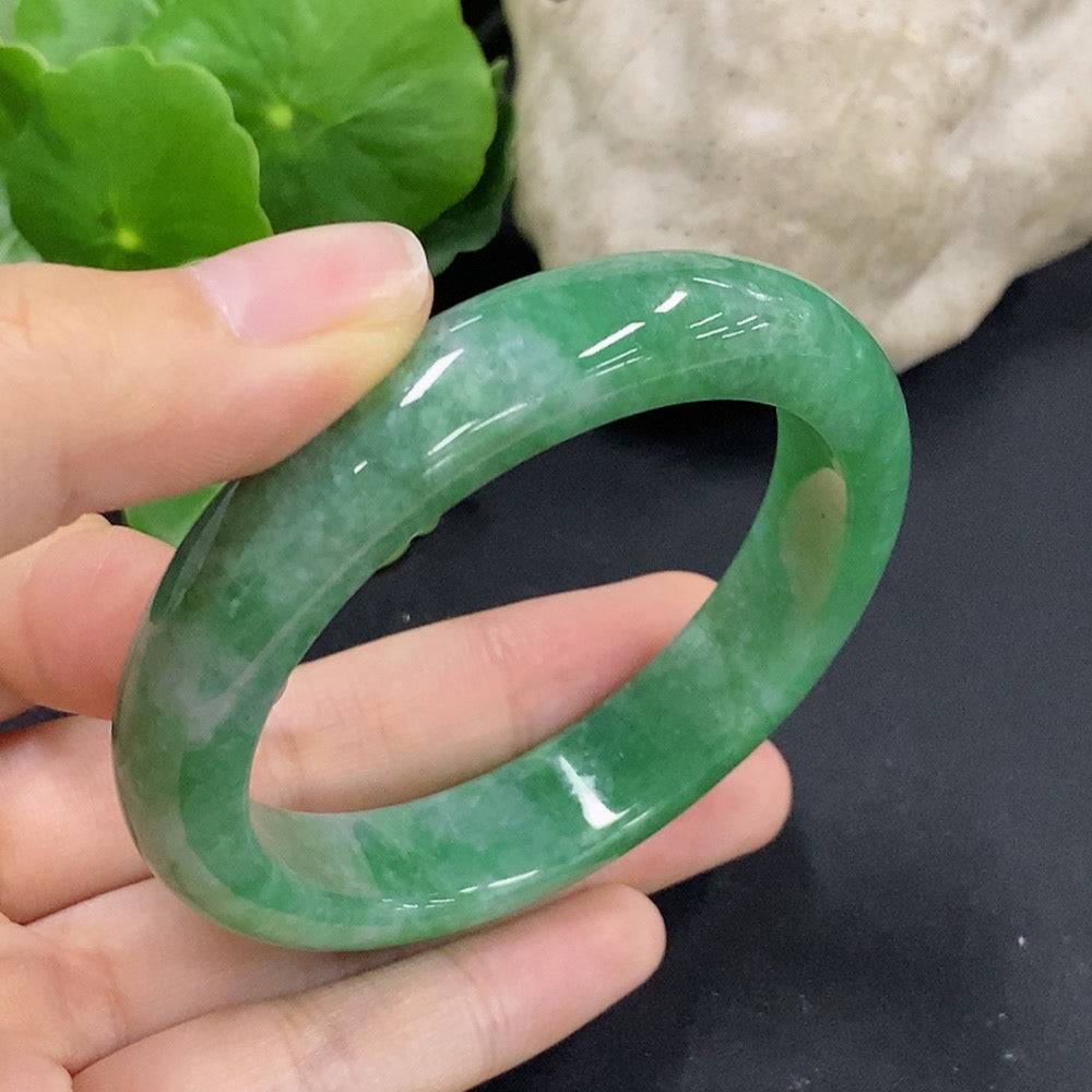Huiliu Certified Jadeite round bangle showcasing smooth, polished green jade with a glossy finish and traditional craftsmanship.