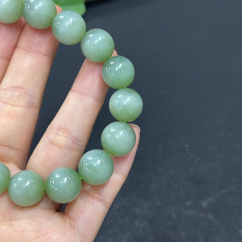 HKHQ Hetian Jade bracelet with 11.6mm beads, weighing approximately 43g, showcasing smooth, polished jade stones.