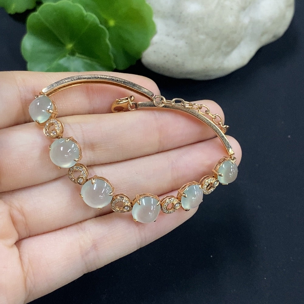 Jadeite cabochon bracelet set in 18K gold with diamond accents, total weight approximately 10.85g