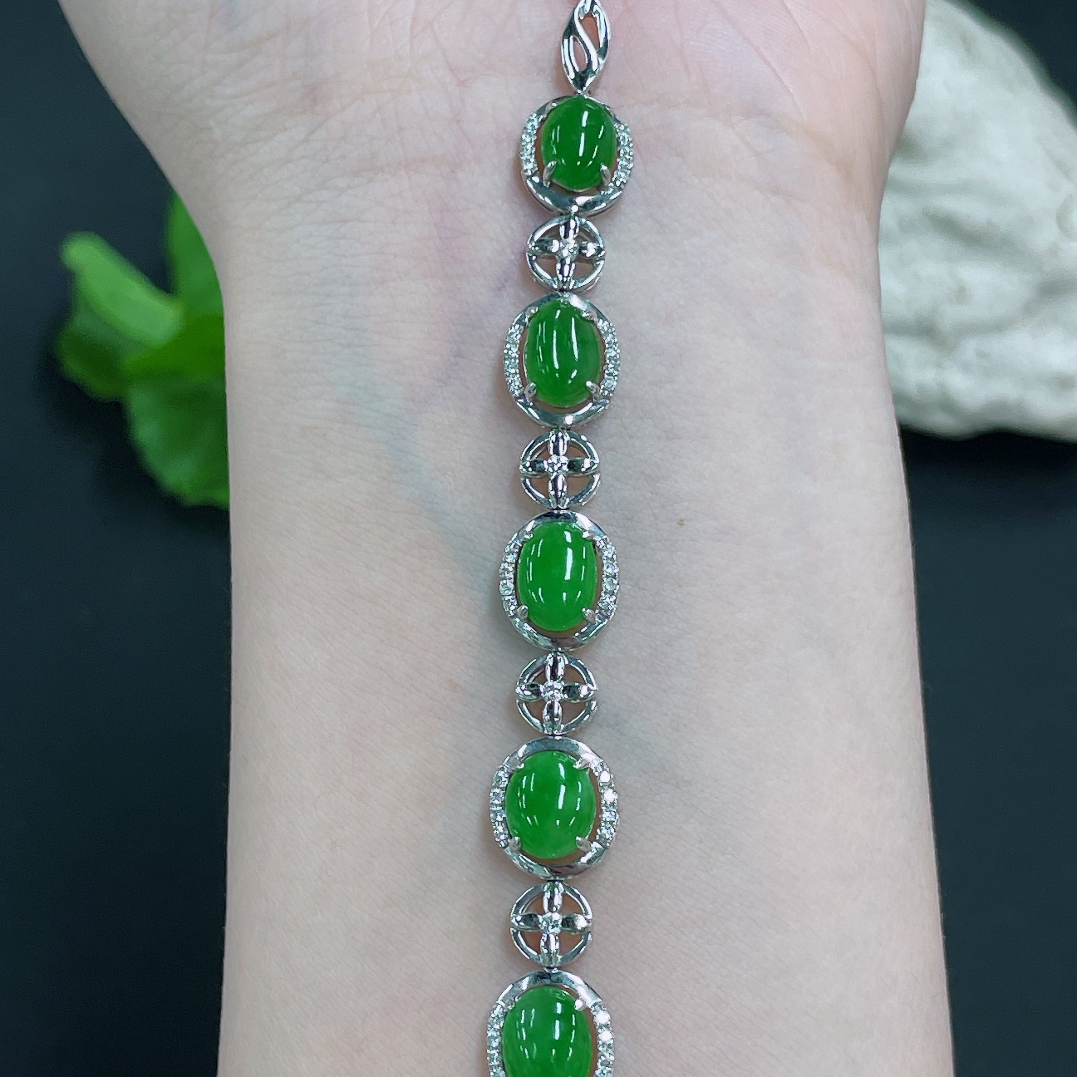 Huiliu jadeite bracelet inlaid with diamonds, showcasing smooth green jade and sparkling diamond accents in a close-up view.