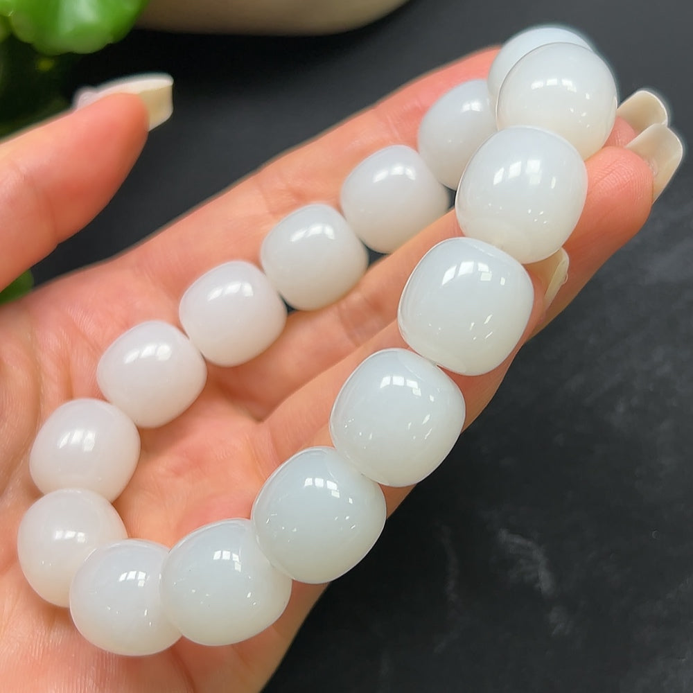HKHQ Hetian Jade bracelet weighing 87.51g, featuring smooth, polished green jade beads on a flexible string.