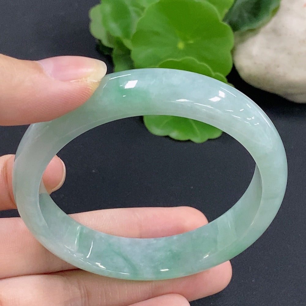 Jadeite round bangle with a size of 57, weighing 51.9g, showcasing smooth, polished green jadeite from HKHQ.