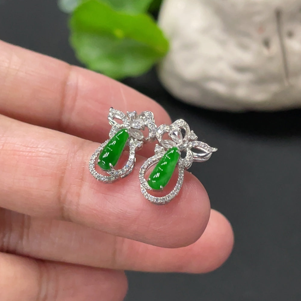 Huiliu Jadeite Lucky Bean earrings pair with small diamond accents, showcasing smooth green jade and delicate details.