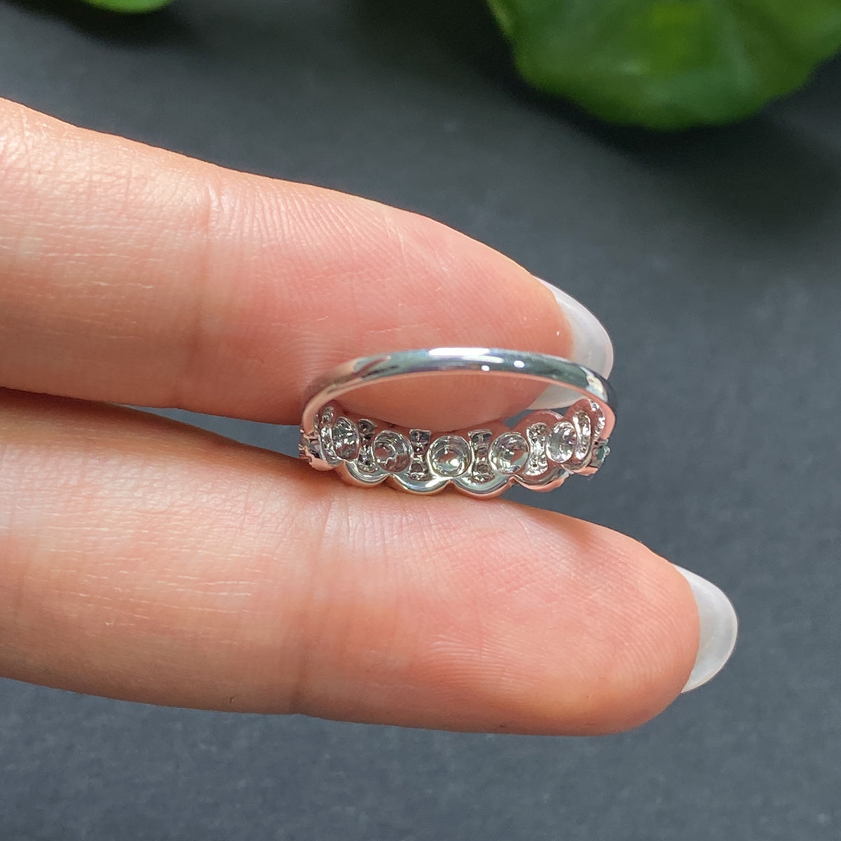 Jadeite ring in 18K gold with diamond accents, featuring a smooth jadeite gemstone and intricate gold band design.