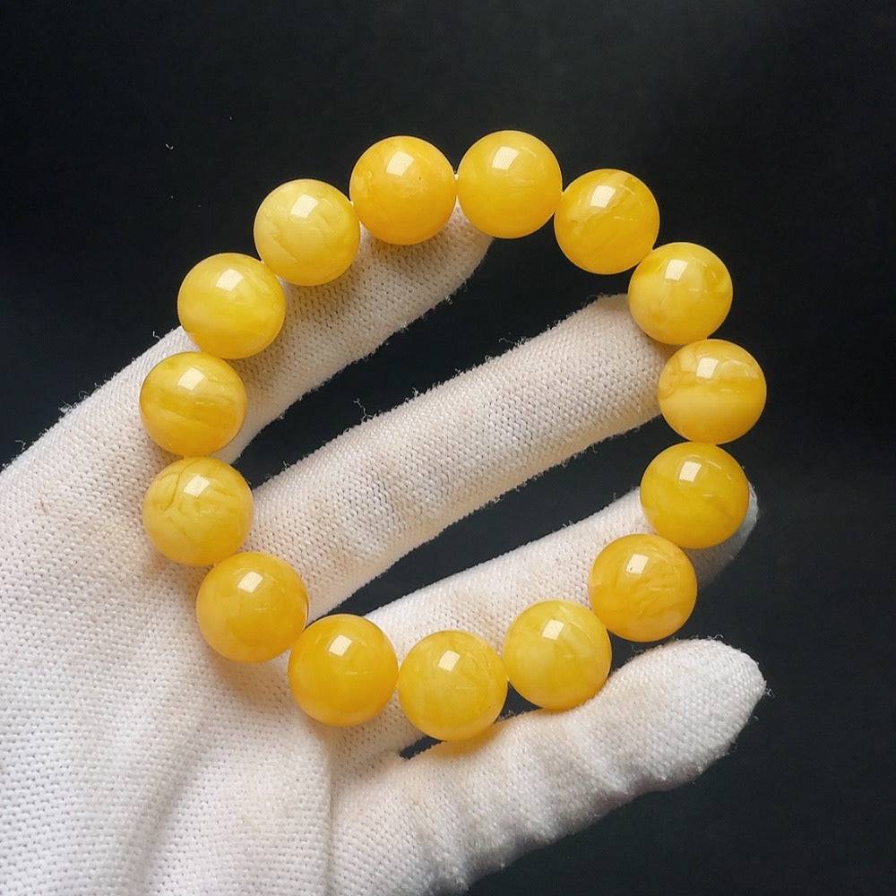 Amber Beeswax bracelet from HUILIU HQ with 14.1mm amber beads, weighing approximately 23.8 grams, featuring warm amber tones.