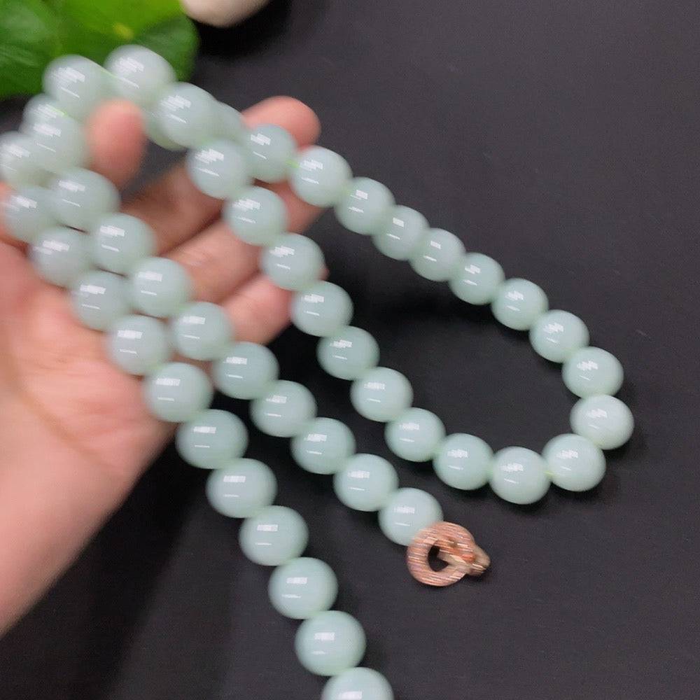 Huiliu Jadeite bead necklace with 11.5mm jade beads, showcasing smooth, polished green jade stones on a string.