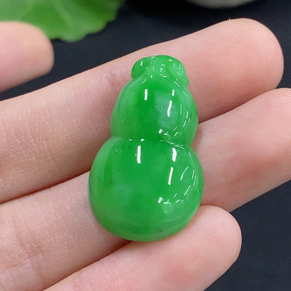 Jadeite gourd inlay piece from HKHQ, featuring smooth green jade with intricate carvings, weighing approximately 4.48 grams.