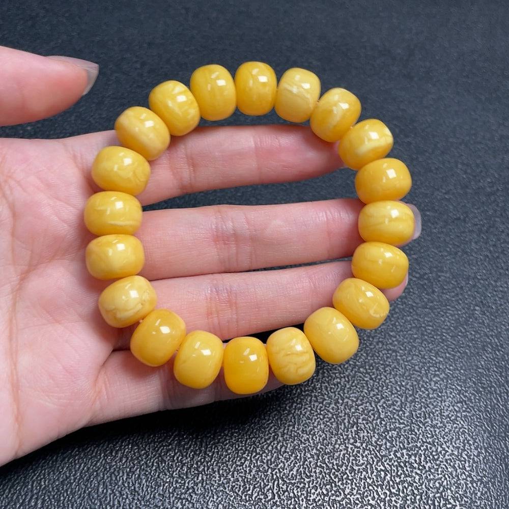 Huiliu Amber Beeswax bracelet with 12.4mm beads, natural amber jewelry featuring warm honey tones and a smooth finish.