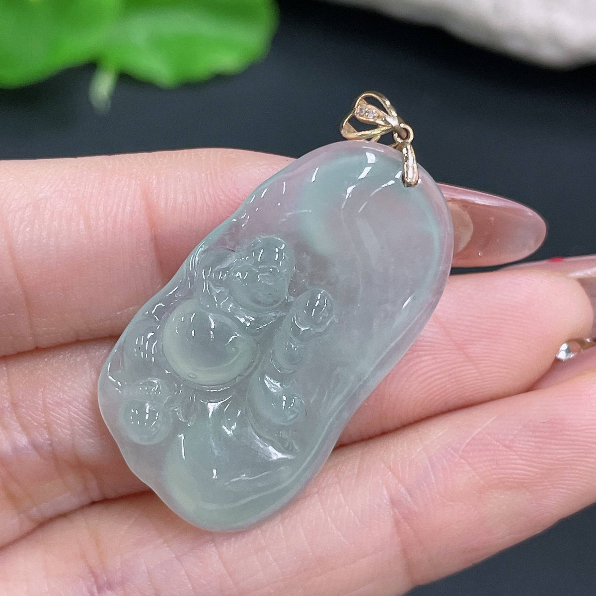 Huiliu jadeite Buddha pendant with bezel, showcasing a polished green jade Buddhist figure on a smooth string.