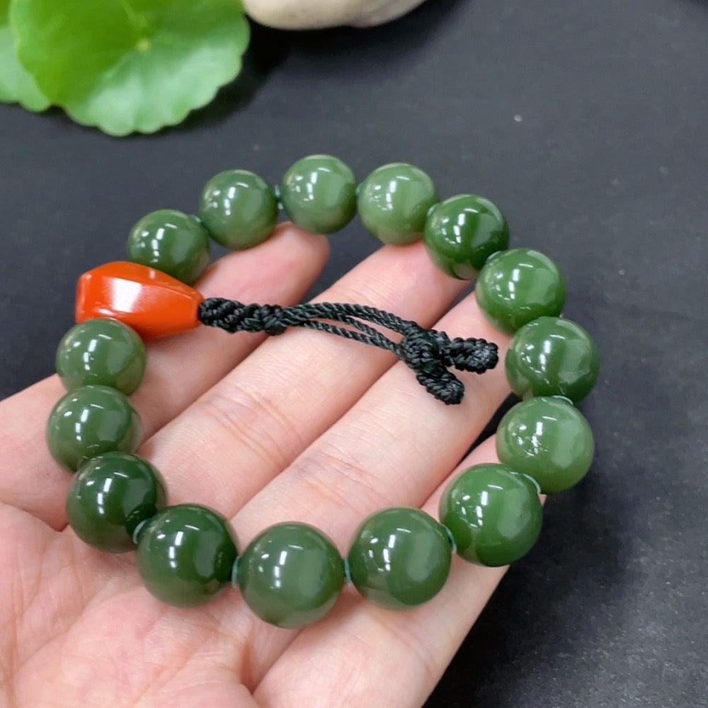 HKHQ Hetian Jade bracelet with 11.5mm beads, weighing about 43.6g, featuring organic southern red accents.