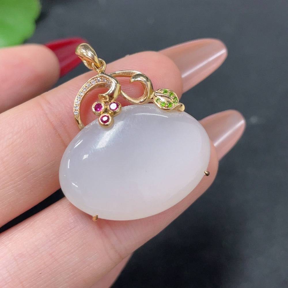Huiliu certified Hetian jade pendant inlaid with colorless diamonds, showcasing elegant craftsmanship and polished jade surface.