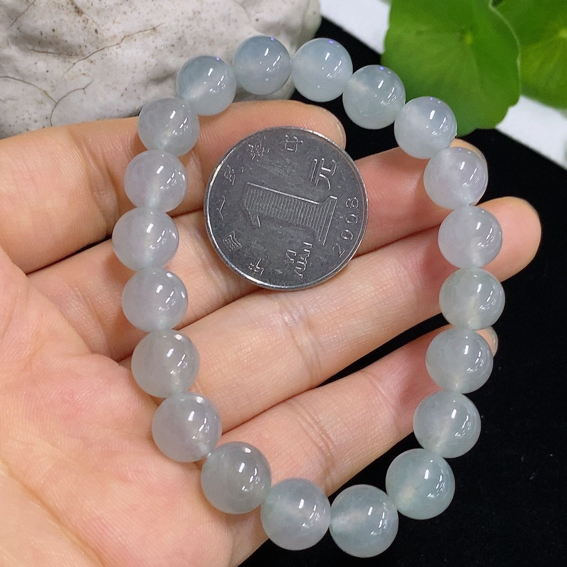 Jadeite bracelet from HKHQ featuring smooth, polished green jadeite beads, weighs 28.68g, on a neutral background.