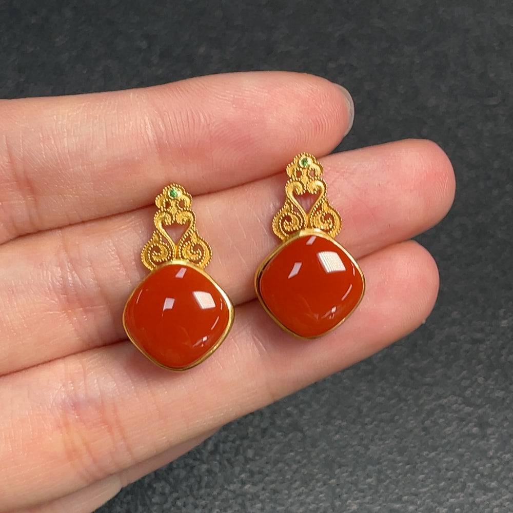 Red agate gemstone earrings with diamond accents, organic matter details, crafted by HUILIU HQ, featuring natural and possibly non-natural stones.