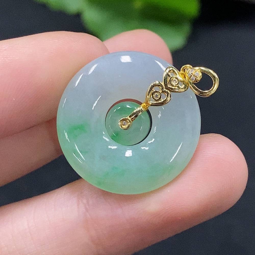 Jadeite mother-and-son button pendant with 18K gold and diamond accents, showcasing intricate craftsmanship and vibrant green jade.