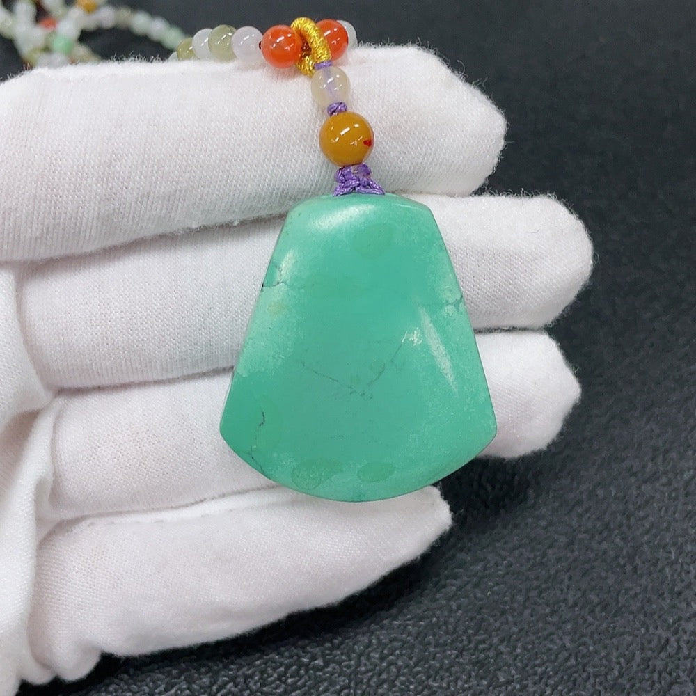 Turquoise pendant with Southern Red Agate, gemstone jewelry featuring mineral components and natural cord attachment.