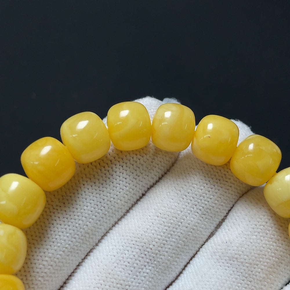 Amber beeswax bracelet from HKHQ featuring 10.6mm amber beads, total weight approximately 14.44 grams, natural and warm-toned.