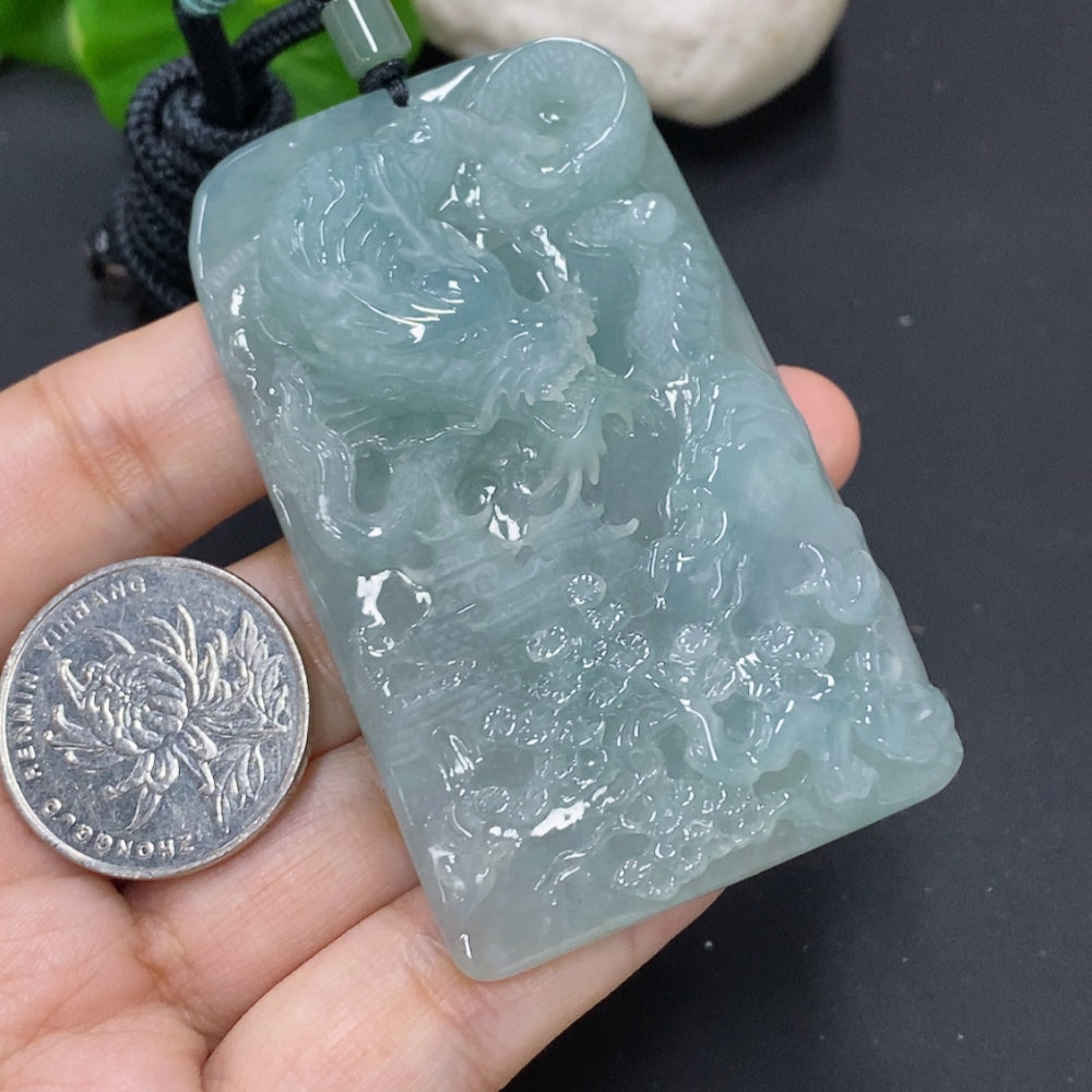 Jadeite dragon pendant with intricate carvings, hanging from a rope, weighing approximately 68.4g, crafted by HKHQ.