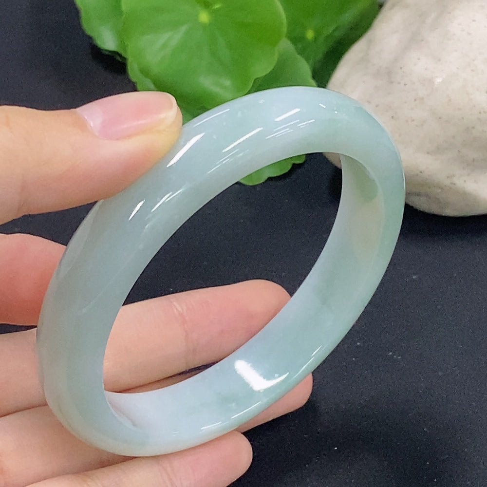 HKHQ jadeite round bangle, size 58.9, weighs approx. 56.8g, showcasing smooth polished surface and vibrant green color.