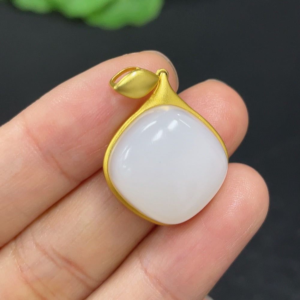Elegant Hetian Jade inlaid pendant necklace with 18K gold setting, featuring a polished jade stone and delicate chain.