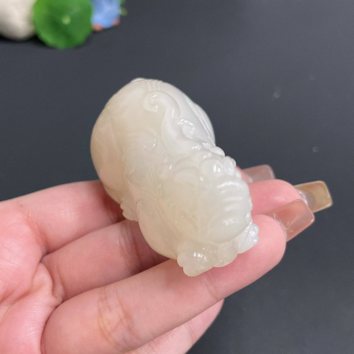 Huiliu certified Hetian jade handheld Pi Xiu figurine, traditional Chinese jade sculpture with intricate details and polished surface.