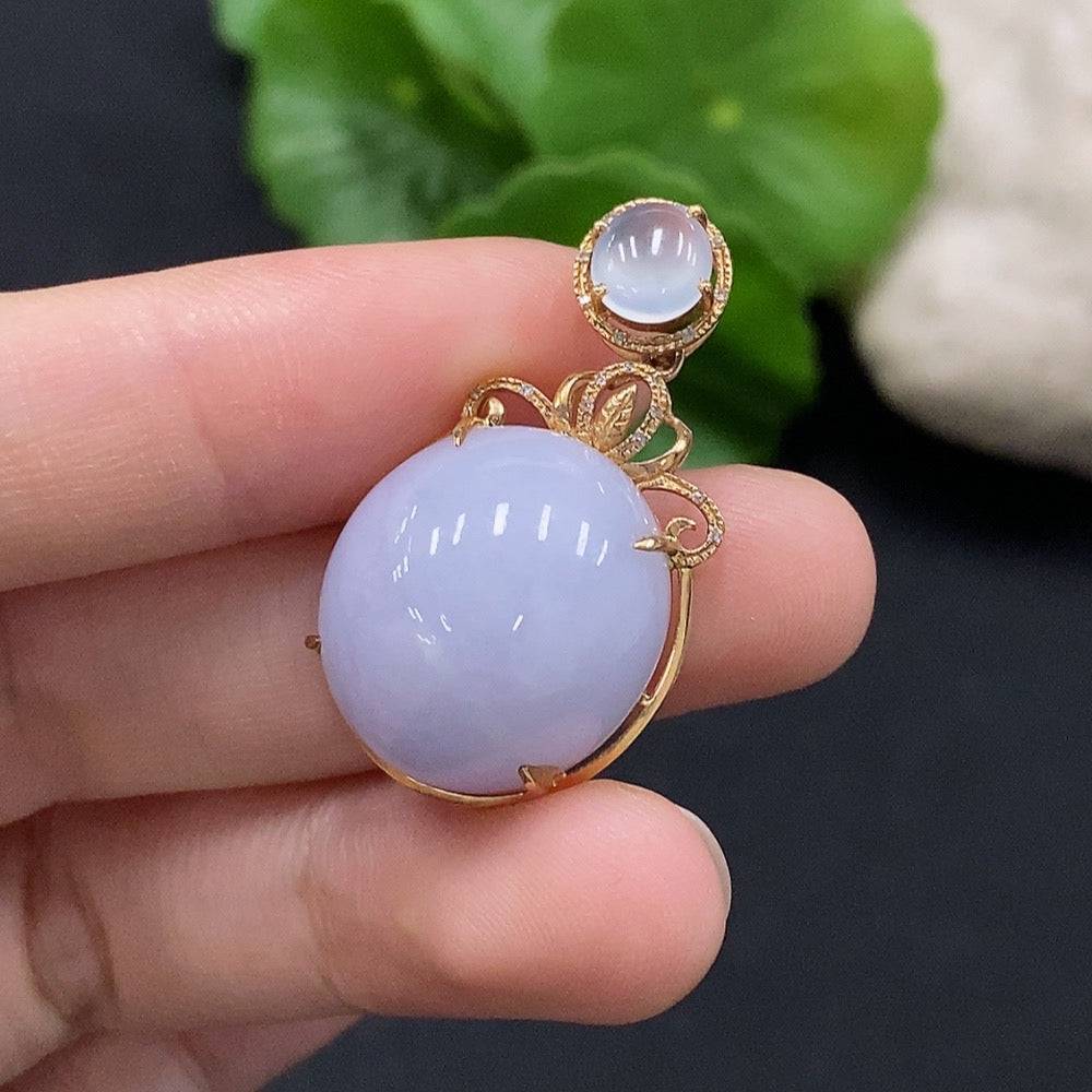 Jadeite cabochon pendant set in 18K gold with diamond accents, showcasing a polished green jade stone and delicate jewelry details.