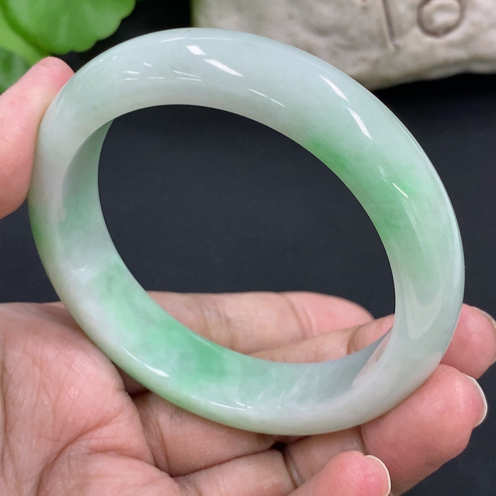 HKHQ jadeite round bangle in size 53.8, weighing 56.6g, showcasing smooth, polished jadeite surface and elegant circular design.