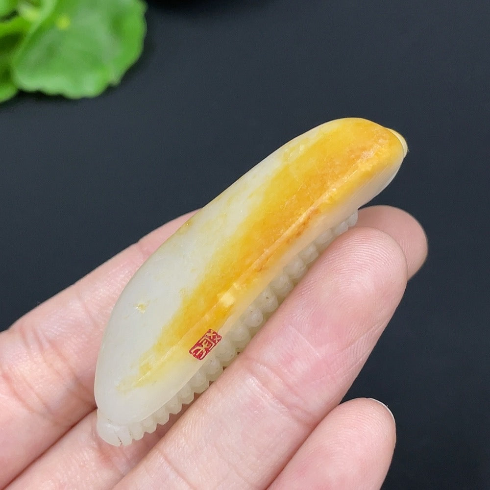 HKHQ Hetian Jade pendant featuring corn-shaped design, natural green color, on a necklace chain, showcasing intricate craftsmanship.
