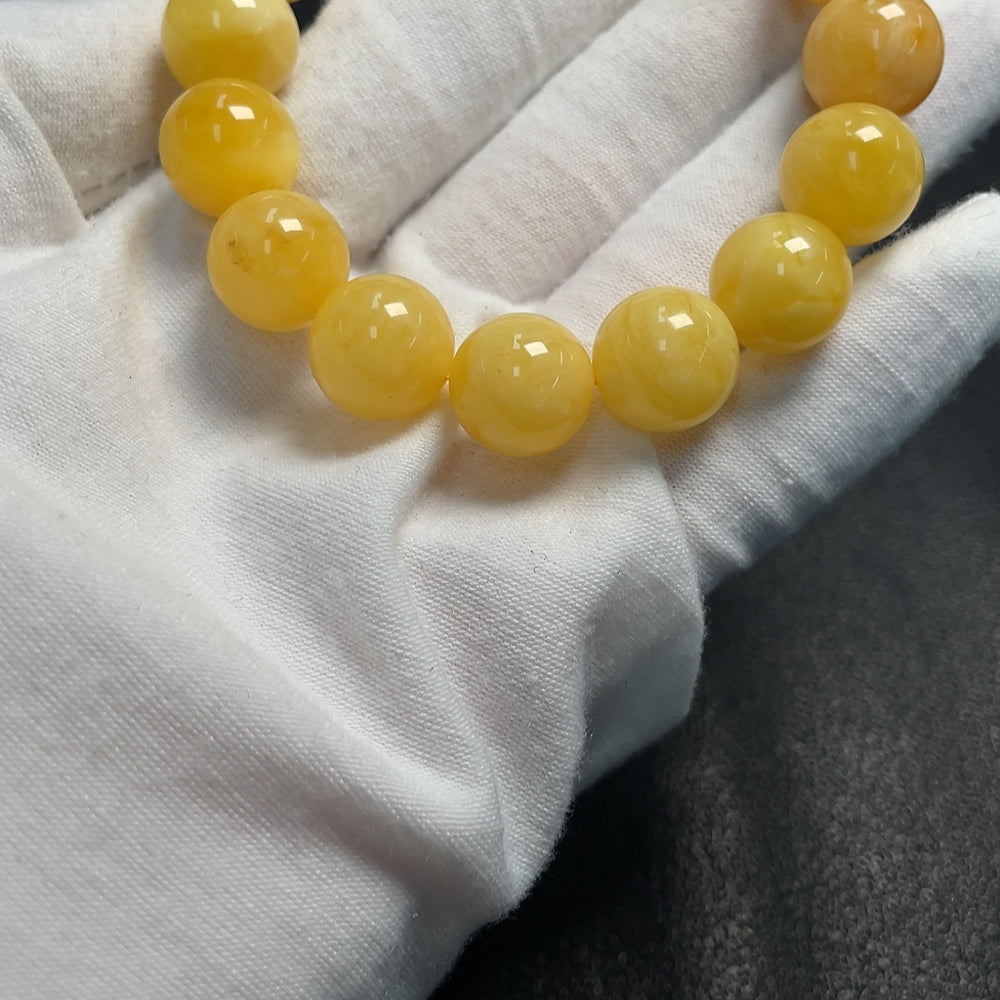 Amber beeswax bracelet with partial visible repairs, total weight approximately 18.25g, size about 12.6mm