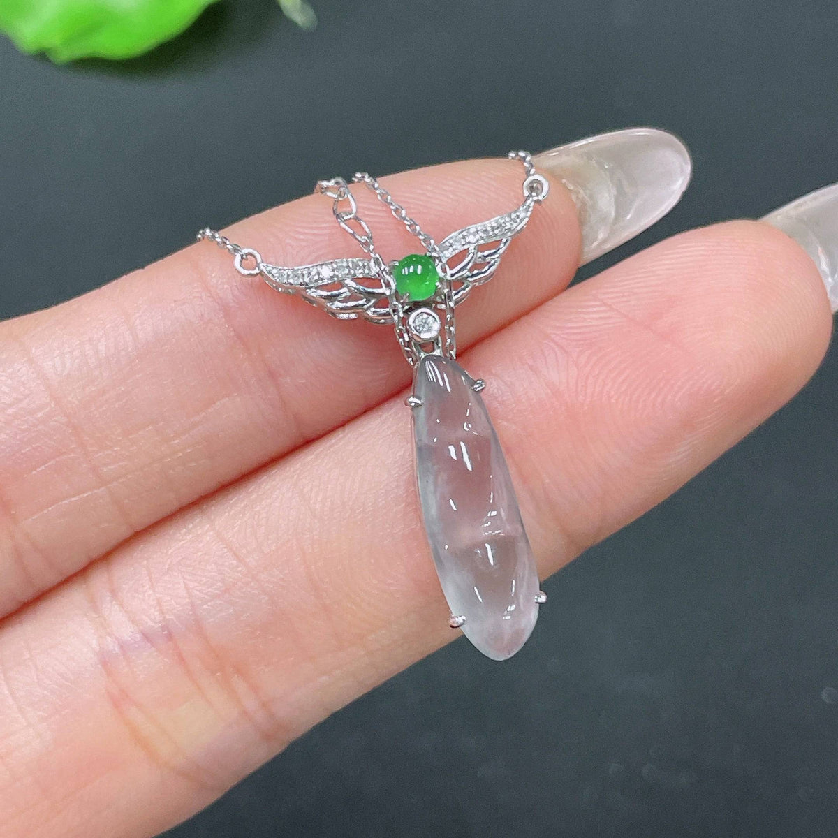 HUILIU HQ jadeite bean pendant in 18k gold set with diamonds, featuring a delicate chain and a polished jade gemstone.