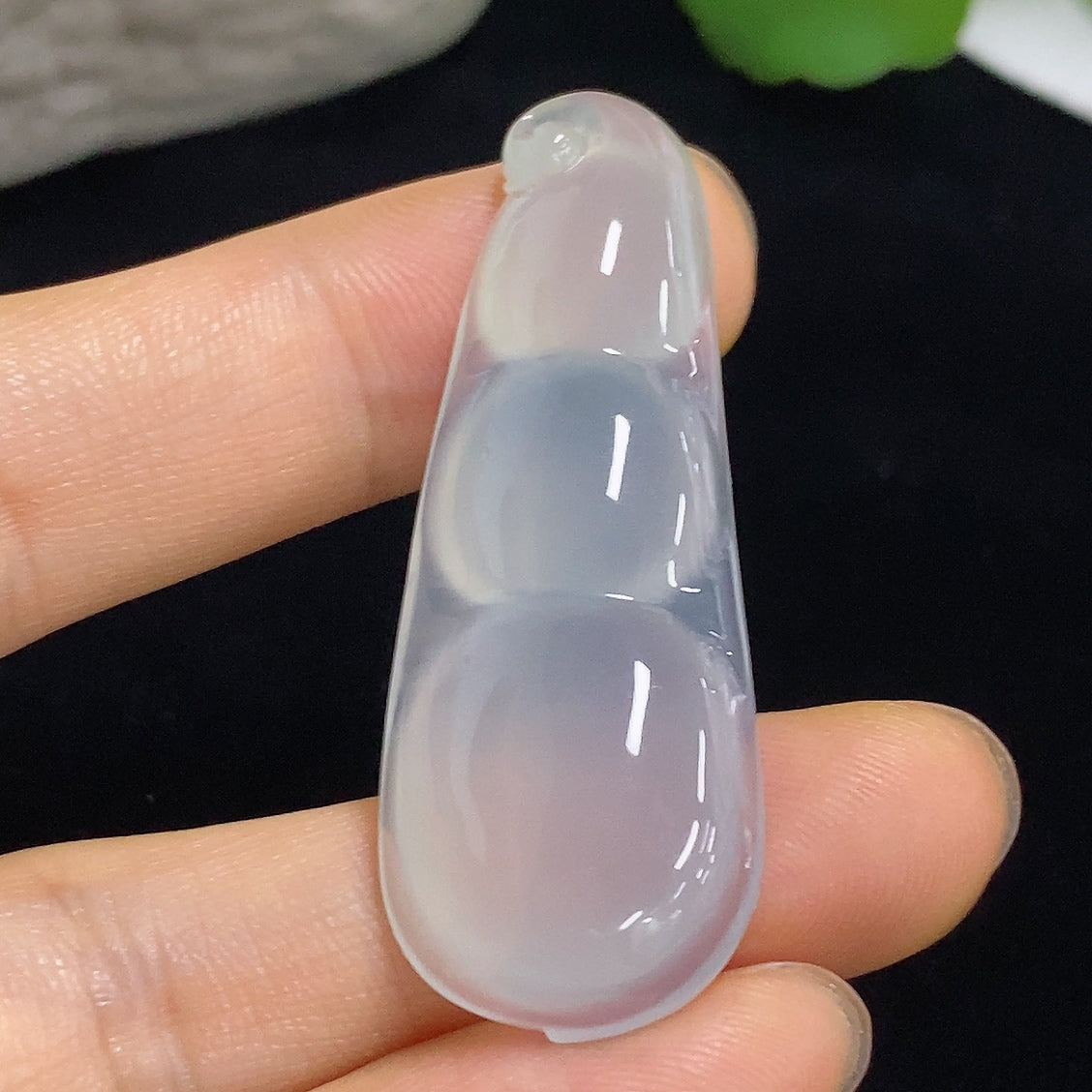 Jadeite pendant with Fu Dou design, weighing approximately 9.8g, crafted by HKHQ, featuring smooth green jade surface and intricate shape.