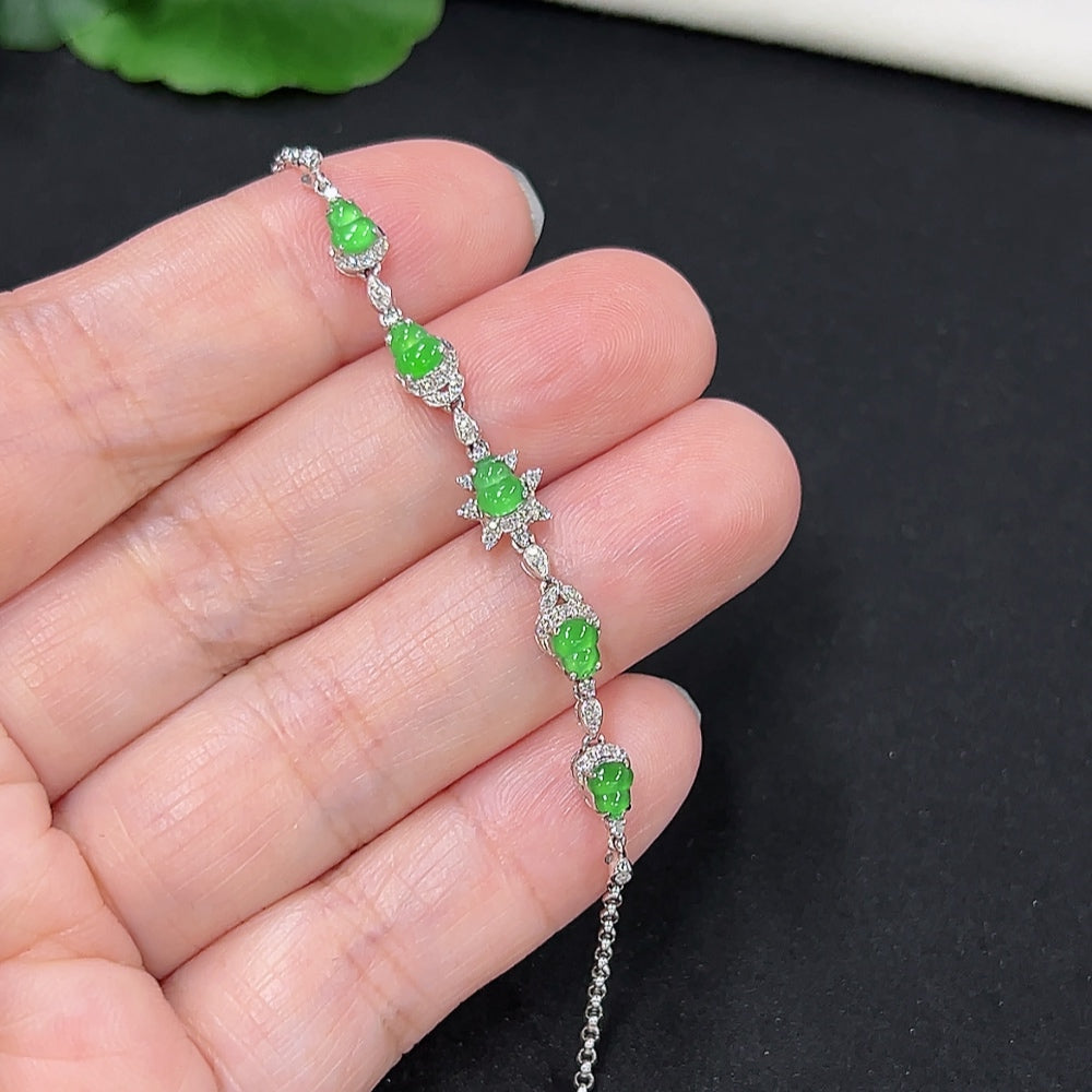 Jadeite gourd inlaid bracelet by HKHQ with 18k gold and diamond accents, showcasing intricate design and craftsmanship.