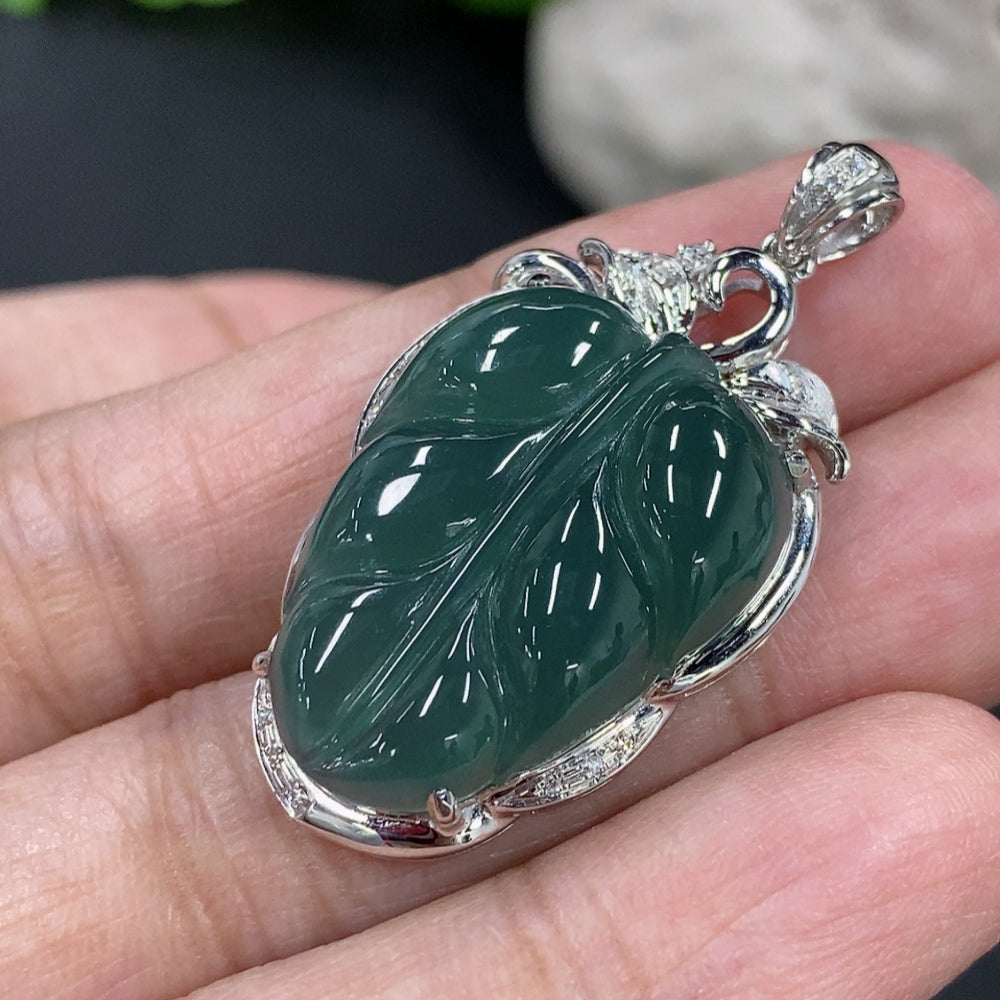 Jadeite leaf inlay pendant necklace by HKHQ with 18K gold and diamond accents, showcasing intricate craftsmanship and elegant design.