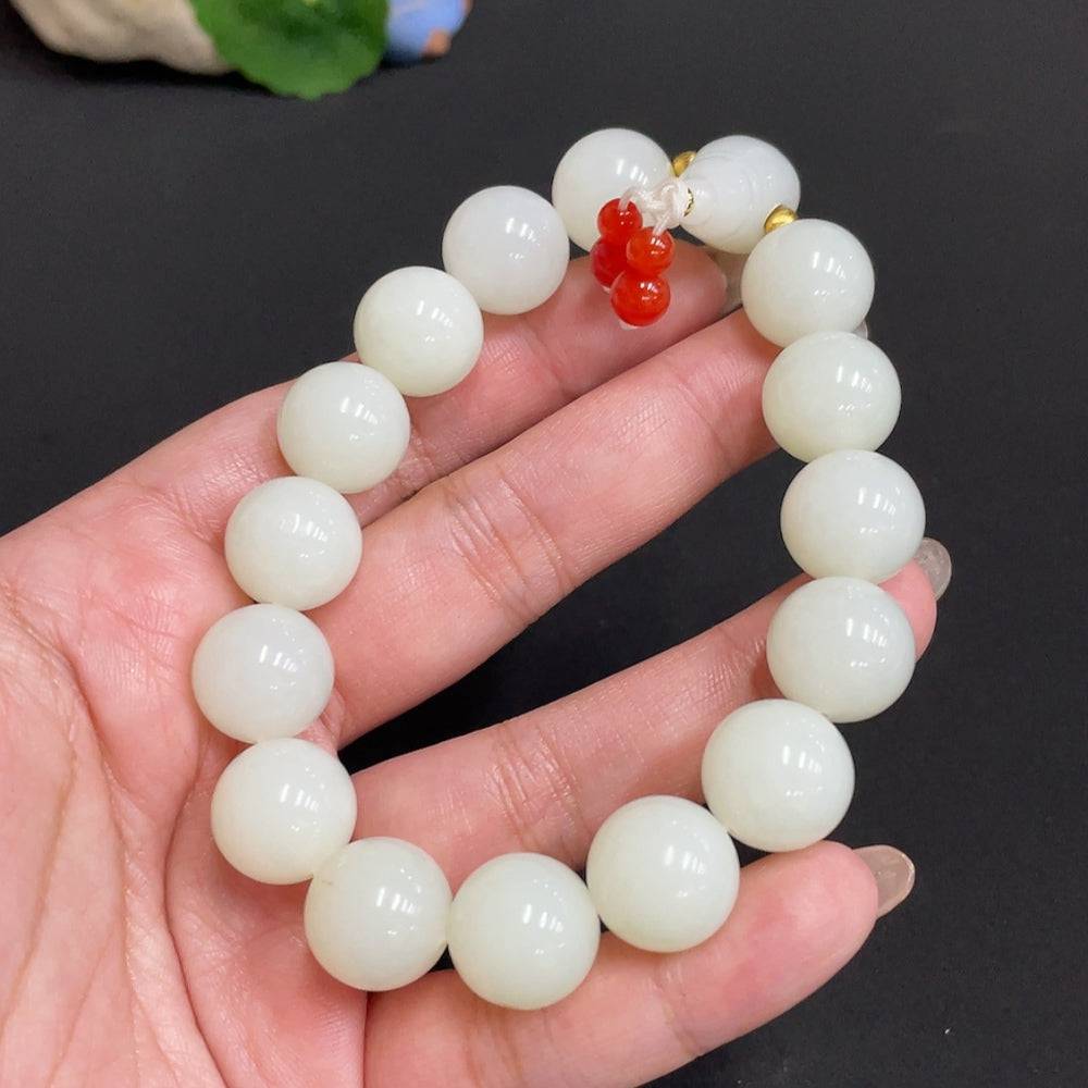 Huiliu Certified Hetian Jade bracelet with 13.8mm smooth jade beads and mineral components, natural and elegant jewelry piece.