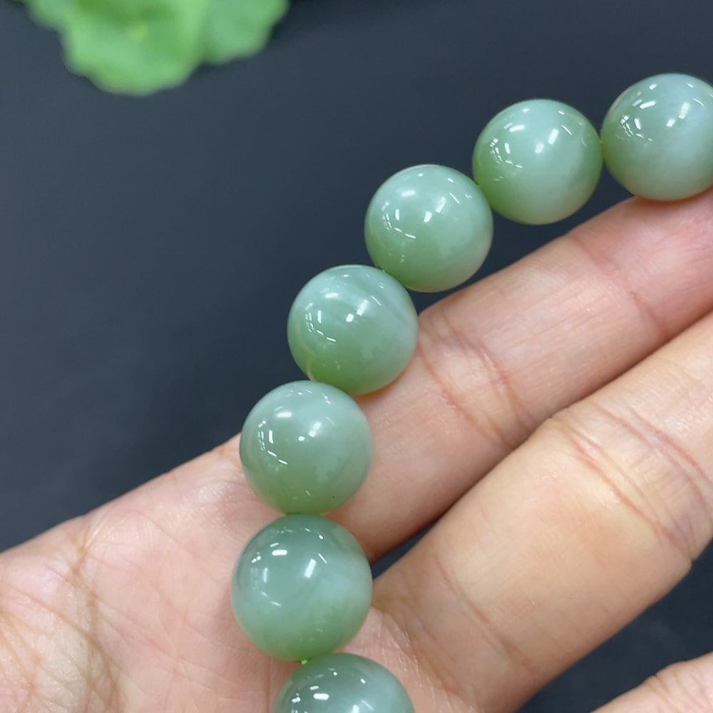 HKHQ Hetian Jade bracelet with 11.6mm beads, weighing approximately 43g, showcasing smooth green jade stones.