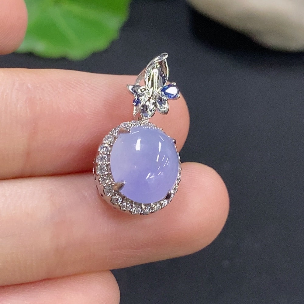 Jadeite cabochon pendant with 18k gold and diamond accents, showcasing a polished green jade stone and intricate gold detailing.
