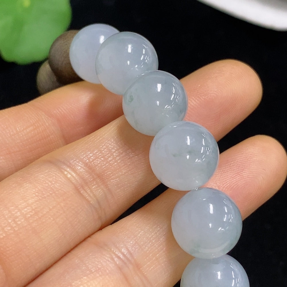HKHQ Jadeite beads 12.5mm, smooth and polished, showcasing vibrant green jade with natural variations, certified by Huiliu.
