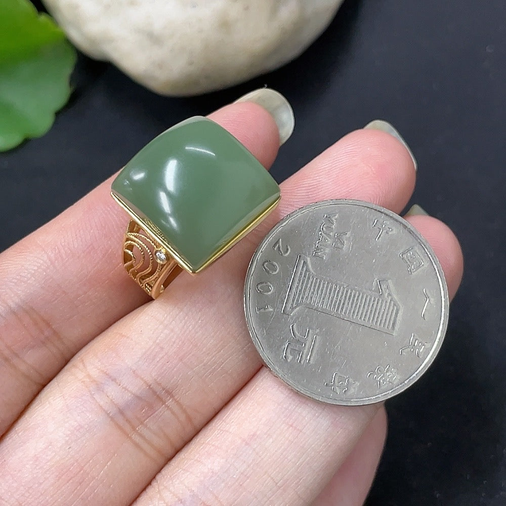 Hetian jade inlaid ring with diamond accents in 18K gold, showcasing intricate craftsmanship and elegant design.