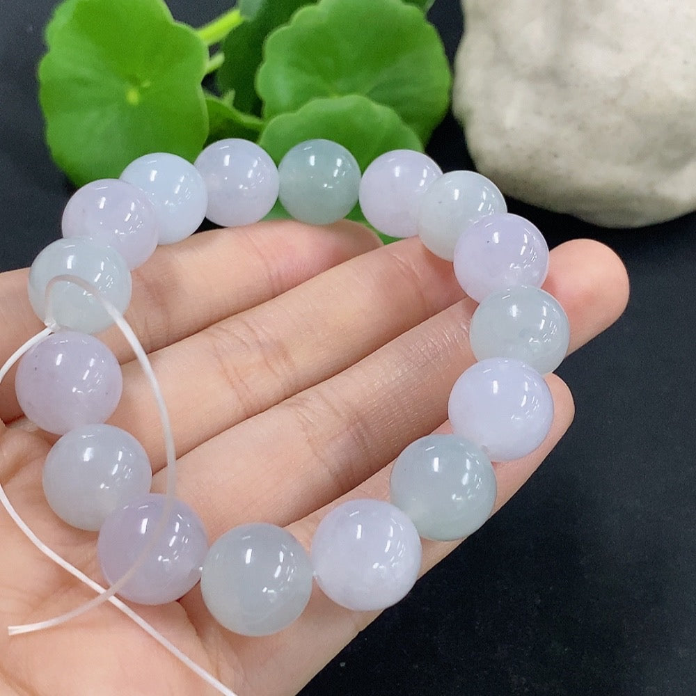 Jadeite bracelet weighing 48.59g featuring smooth, polished green jade stones strung together, showcasing elegant craftsmanship.