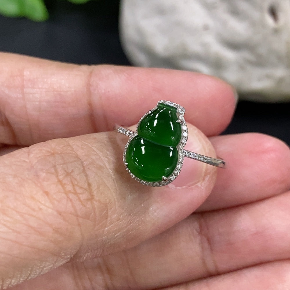 Jadeite gourd inlaid ring with 18K gold band and diamond accents, featuring intricate craftsmanship and elegant design.