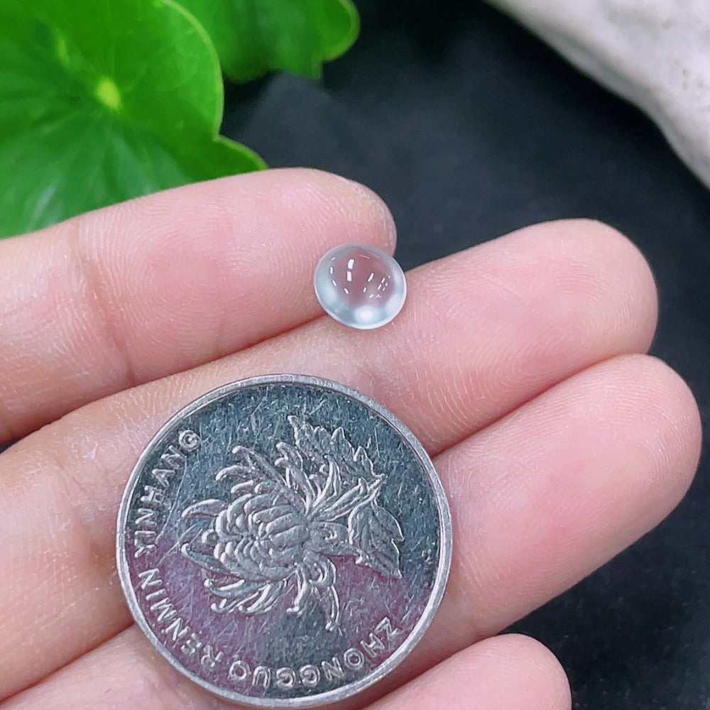 Small jadeite cabochon jewelry piece from HKHQ, showcasing a smooth, polished green stone with subtle natural patterns.