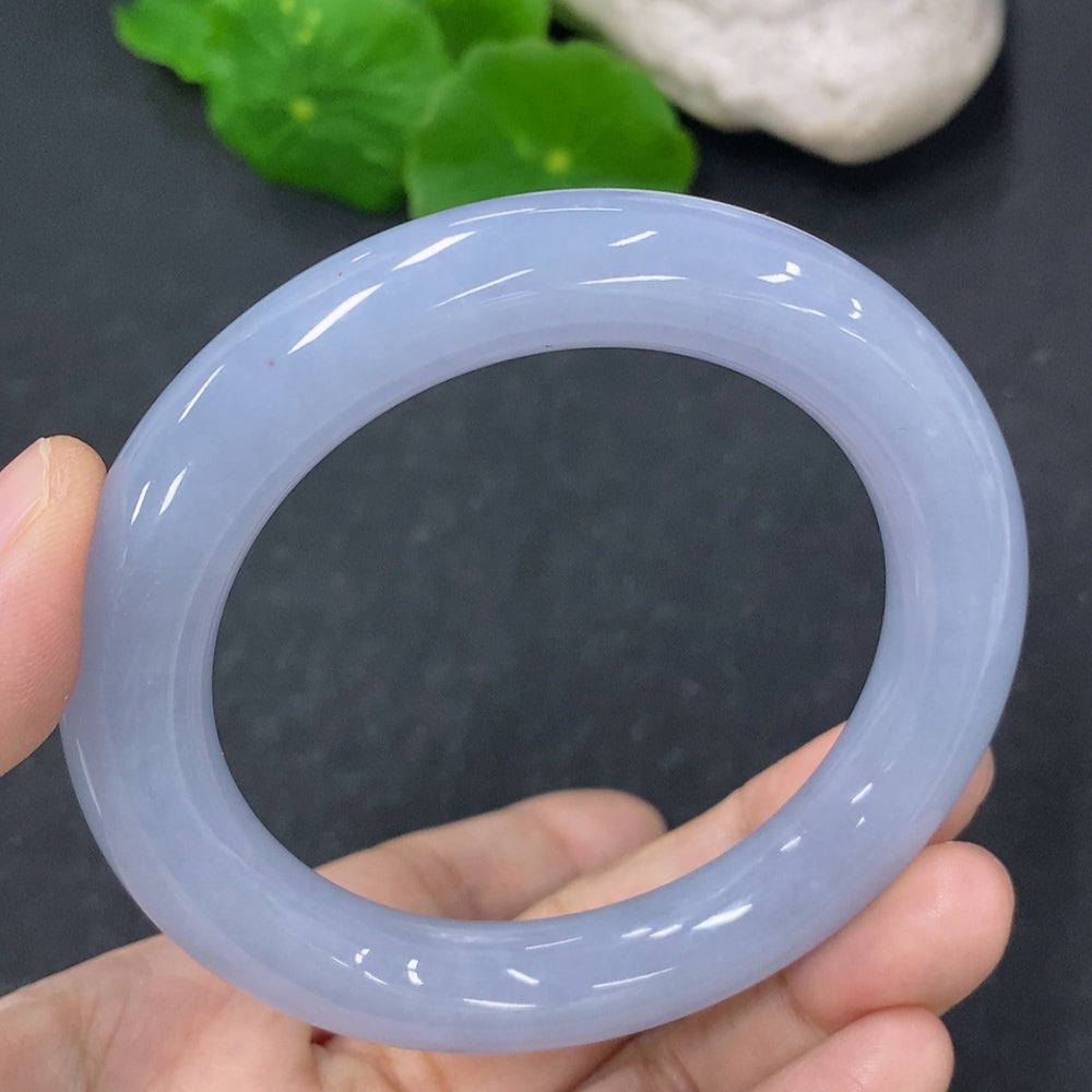 Elegant jadeite round bangle from HKHQ, showcasing smooth, polished jade jewelry with a glossy finish.