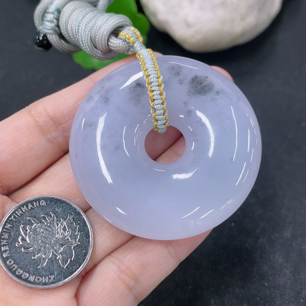 Jadeite pendant donut with rope, weighing approximately 42.54g, showcasing smooth green jade and a polished finish.