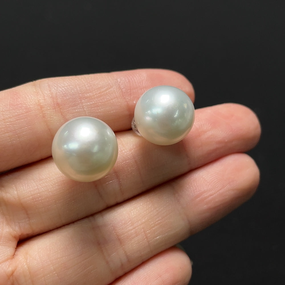 Saltwater pearl earrings with 18K gold hooks, featuring elegant white pearls and delicate gold accents.